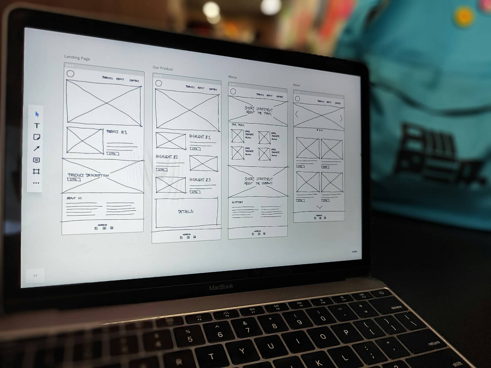 5 Website Design Features That Increase Conversions — Hero Image Website design wireframe displayed on a laptop screen on an office desk
